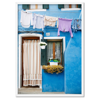 Bright Blue Terrace Washing Burano - Art Print by Victoria's Stories, Poster, Stretched Canvas, or Framed Wall Art Print, shown in a white frame